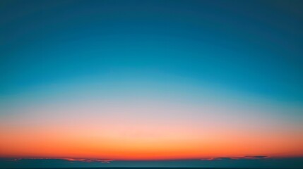 At sunset, the sky displays a beautiful gradient of orange to blue, creating a breathtaking and picturesque view.