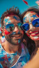 Couple with sunglasses and face paint alluding to usa takes a selfie. 4th of July celebration