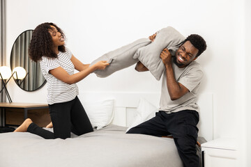 Couple Having Pillow Fight In Bedroom, Fun Home Lifestyle, Happy Playful Moment, Indoor Leisure Activity
