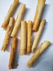Kue semprong or Asian egg roll. This is a traditional Indonesian wafer or kuih snack isolated on a white background