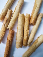 Kue semprong or Asian egg roll. This is a traditional Indonesian wafer or kuih snack isolated on a white background