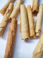 Kue semprong or Asian egg roll. This is a traditional Indonesian wafer or kuih snack isolated on a white background