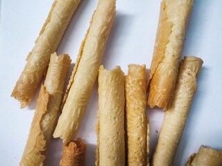 Kue semprong or Asian egg roll. This is a traditional Indonesian wafer or kuih snack isolated on a white background