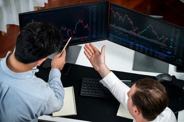 Business professional brokers discussing stock market on pc screen in real time, analyzing dynamic exchange rate database graph or interesting unit investment for trading in valued growth. Sellable.