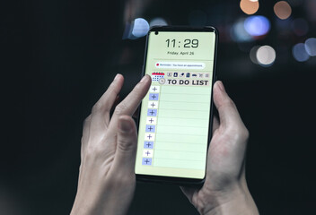 Reminder list concept. Woman uses smartphone application to record to-do list and reminders of...