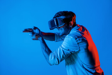 Caucasian smart man wearing VR glass and moving gesture holding gun. Gamer using future digital virtual reality headset or futuristic innovation to enter meta world or playing action game. Deviation.