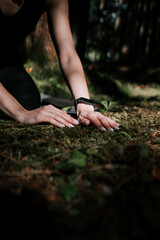 A young woman does yoga and meditates in the forest. Yoga and meditation concept. Yoga asanas. 