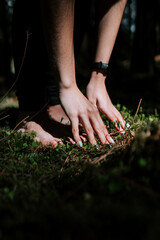A young woman does yoga and meditates in the forest. Yoga and meditation concept. Yoga asanas. 