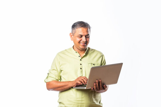 Indian asian mid age man using laptop against white background