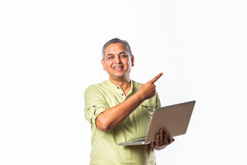 Indian asian mid age man using laptop against white background