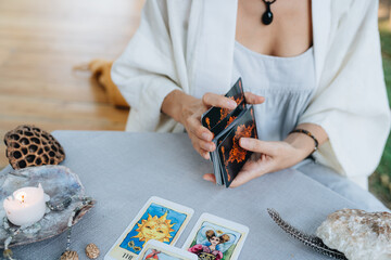 A woman is making tarot layout on the table