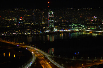 Fototapeta na wymiar Skyline of Vienna at night with Millennium Tower near the New Danube River. View from the observation deck of the Danube Tower, Austria
