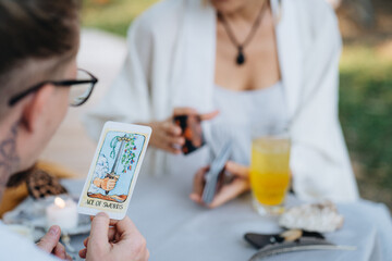 A customer looking at a tarot card