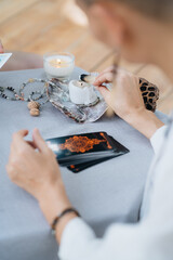 A woman is making tarot layout on the table