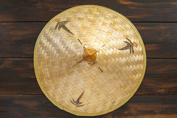 Chinese bamboo hat on dark wooden background..