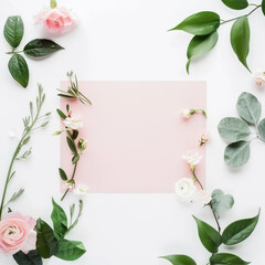 Naklejka premium Pink sheet of paper on a white table with flowers around 