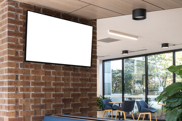 A mockup background texture of a TV or electronic digital screen mounted on a wall in a public indoor waiting area. A blank white advertisement display or notice board in a hall. Copy space for design