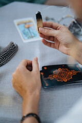A woman is making tarot layout on the table