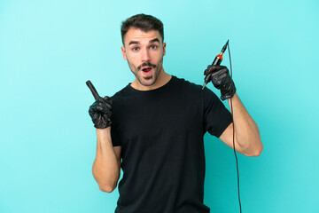 Young tattoo artist man isolated on blue background intending to realizes the solution while...