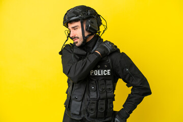 SWAT caucasian man isolated on yellow background suffering from pain in shoulder for having made an...