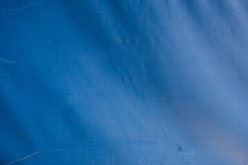 abstract background of old dirty blue tarpaulin close up