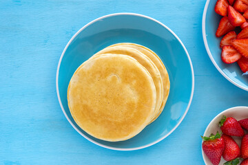 Pancakes for tasty breakfast on blue ceramic plate.