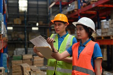 Warehouse workers working with scanner making review of goods in warehouse