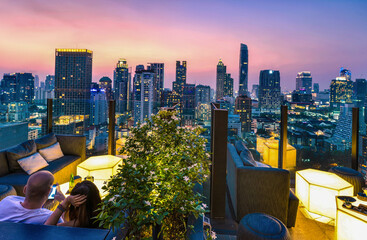 Bangkok city view point from rooftop bar, overlooking a magnificent cityscape blue sky and city...