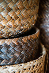Obraz premium The intricate weave patterns of woven baskets made from materials like rattan, wicker, or seagrass. Woven basket textures offer a rustic yet refined backdrop with a touch of natural charm. 