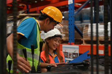 A forklift truck operator talking to a manager or supervisor in a logistic warehouse, Distribution warehouse management concept