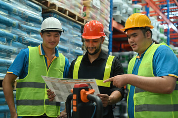 Manager and warehouse employees meeting a plan at a distribution warehouse, Logistic inventory teamwork concept