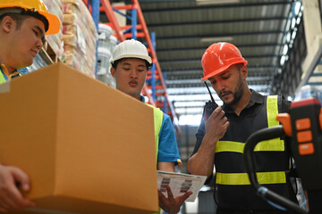 Warehouse worker Caucasian man with team using walkie talkie radio to control stock and inventory in retail warehouse logistics, distribution center