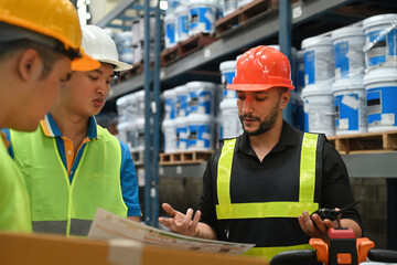 Teamwork men in the industrial warehouse concept, professional foreman in safety helmet hard hat talking with team