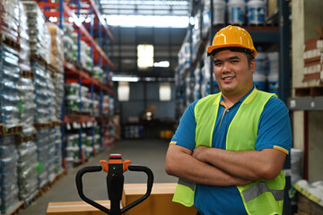 Portrait of Asian Warehouseman or factory worker with a uniform in arm crossed and looking at camera