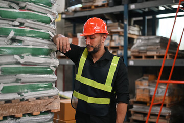 Depressed Caucasian ethnicity warehouse worker feel tired after overwork and disappointed for his job or being fired - obrazy, fototapety, plakaty