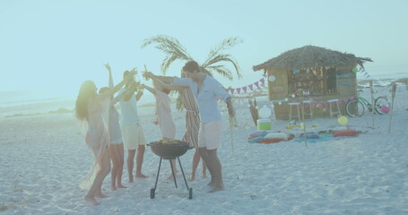 Fototapeta premium Group of friends enjoying a beach barbecue at sunset