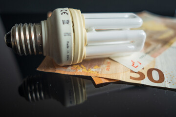 Light bulb with 50 euro note bills , Increase in electricity tariffs