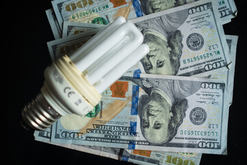 Light bulb with 100 usd note bills , Increase in electricity tariffs