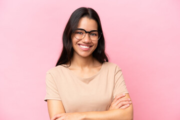 Young Colombian woman isolated on pink background With glasses with happy expression