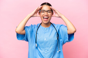 Young nurse Colombian woman isolated on pink background with surprise expression