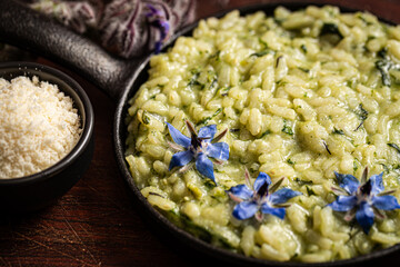 Indulgent risotto elevated by fragrant borage leaves.
