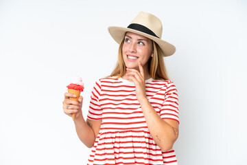 Young caucasian woman holding a cornet ice cream isolated on white background thinking an idea...
