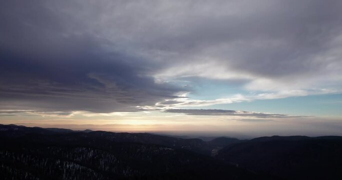 aerial view of dramatic sunset clouds over forest covered mountains near Cloudcroft, New Mexico