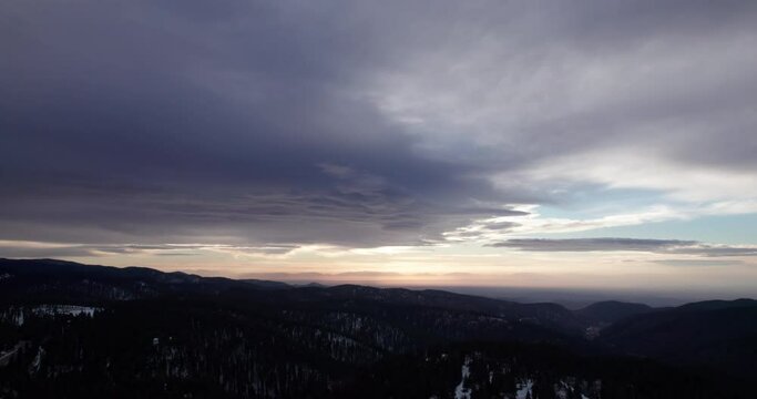 A dramatic sunset with beautiful clouds over the mountains near Cloudcroft, New Mexico, aerial view
