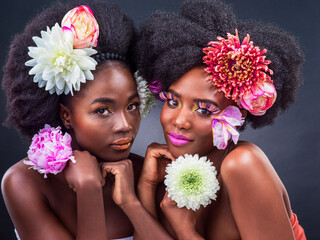 Portrait, beauty and black women with spring flowers in studio for organic cosmetics, makeover or...