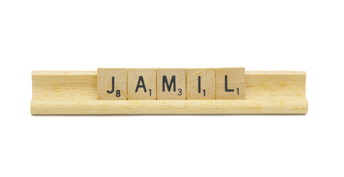 Miami, FL 4-18-24 popular baby boy first name of JAMIL made with square wooden tile English alphabet letters with natural color and grain on a wood rack holder isolated on white background