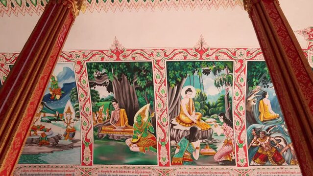 Colorful religious paintings on the interior of Pha That Luang Golden Stupa Buddhist Temple in Vientiane, Laos