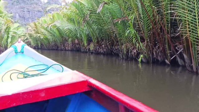 Traditional boats cruise over a river visiting geological sites in Ramang-Ramang village, Maros, South Sulawesi, Indonesia.