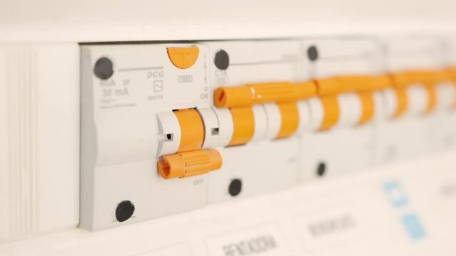 Close-up of man turning off the fusebox
