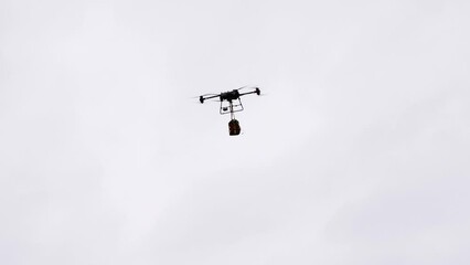 Industrial delivery drone transport heavy medical emergency bag in bright sky